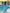 Woman in a blue dress standing by a pool at sunset.