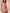 A woman modeling a pink and white patterned two-piece bikini against a solid beige studio background.